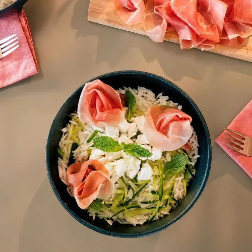Bowl di riso basmati con prosciutto crudo, zucchine a nastri, feta e menta