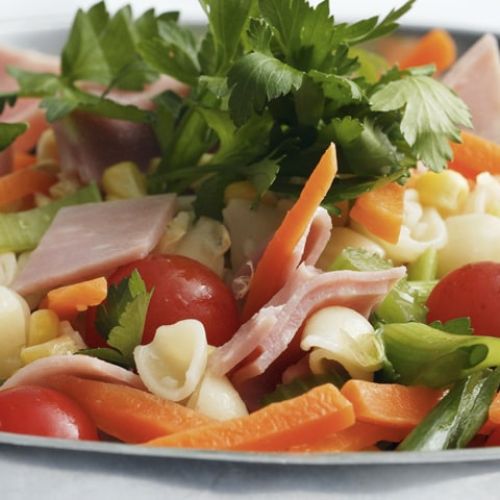 Pasta salad with ham, avocado and tomatoes