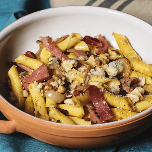 Garganelli con fave, speck e trito di frutta secca, ricetta