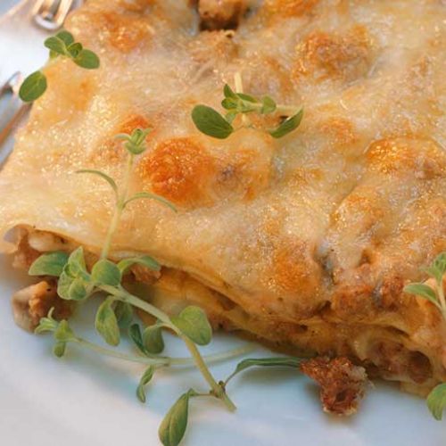 Lasagne filled with aubergine, cooked ham and sausage
